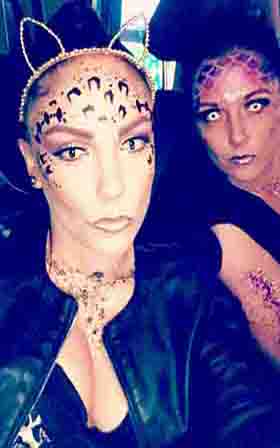 Two ladies one with face painted