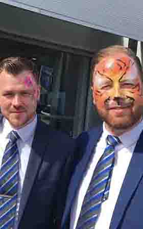 Two men adults one with face painted